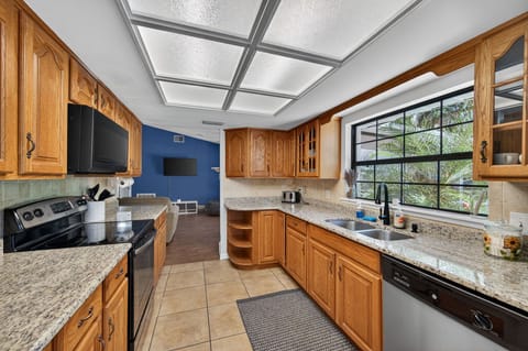 Bright kitchen with granite countertops and large window for natural light.