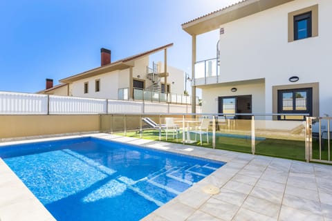 Back of villa with pool and view towards back of property.