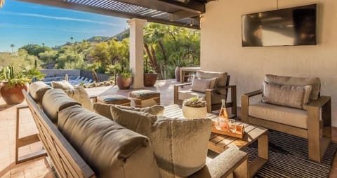 Rear patio with space heaters for chilly nights, TV, and canyon and city lights views.