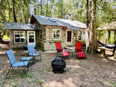 Charming log cabin with charcoal BBQ and firepit.