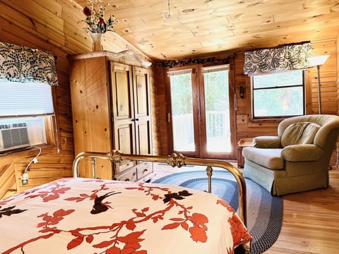 Upper level master bedroom that opens onto a small deck overlooking the backyard. 