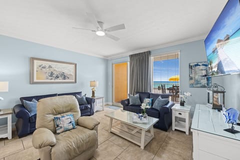 Relax in this cozy living room with ocean views and access to a balcony.
