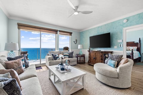 `Relax in your bright coastal living room where soft breezes and stunning ocean views greet you every morning. Sink into plush seating, unwind, and let the soothing blues of the sea become your favorite backdrop.