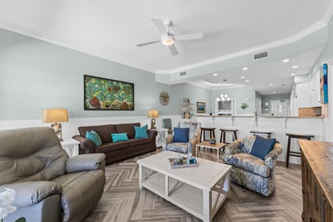Spacious living area with comfortable seating and an open kitchen layout.