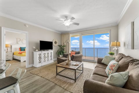 Relax in this modern living room with ocean views from the balcony.