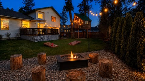 Family-friendly backyard retreat with glowing treehouse, firepit, string lights, and games ~ perfect for making memories together