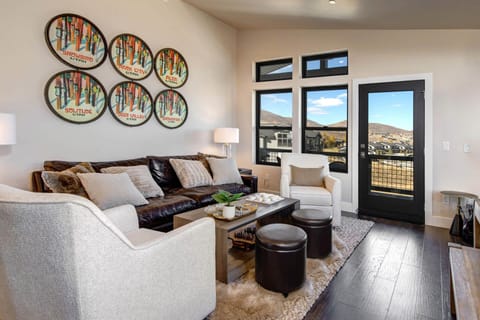 Sink into plush sofas surrounded by ski resort charm and mountain views—your cozy retreat after a day of adventure awaits.