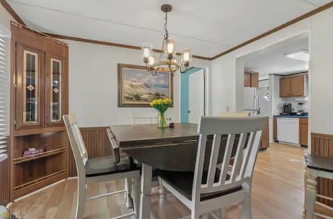 Expandable dining table and chairs to accommodate six.