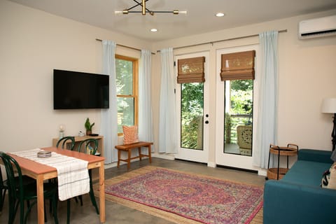 Living space with entrance, TV, and HVAC