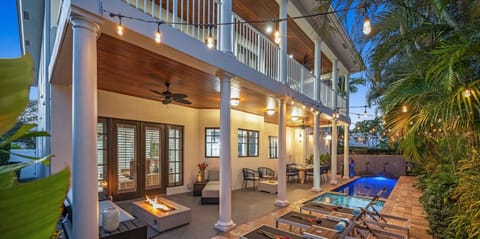 Quintessential Florida Keys style villa updated with modern fixtures, quaint breezy verandas, and towering ceilings. Unwind in the heated pool nestled in a tropical garden.
