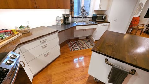 The counter is lowered at the sink with an open under-counter space.