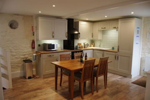 Kitchen with dining area at Forge Cottage in Masham