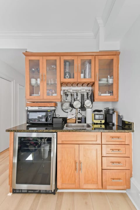 Fully stocked kitchenette with glasses, plates, and cutlery
