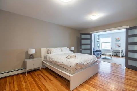 Spacious, cozy bedroom featuring a plush queen-size bed