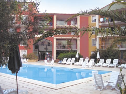Relax under the sun around the outdoor swimming pool.