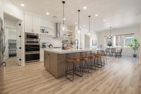 Large, modern kitchen provides an ideal gathering space and has all of the appliances, utensils, and storage for cooking.