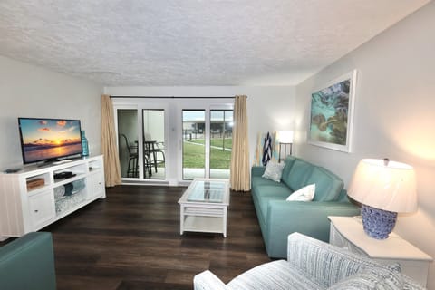 New sleeper sofa & loveseat DEC 2025 - inviting living room with plush seating and direct access to the private patio.