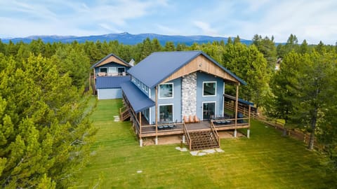 Main home in foreground for guest use.