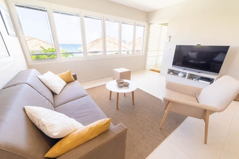 Comfortable living room in the 1st floor flat with sofa bed and view of the sea and the Diamond Rock.