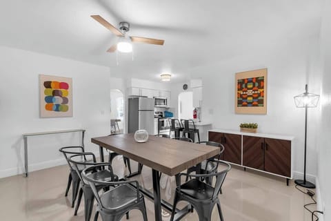 "Gather around in this stylish Airbnb dining space—seats eight, artful decor, and open layout make it perfect for group meals, family stays, and entertaining in comfort."