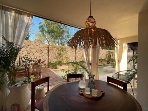 Covered outdoor dining area overlooking the shared swim-up pool