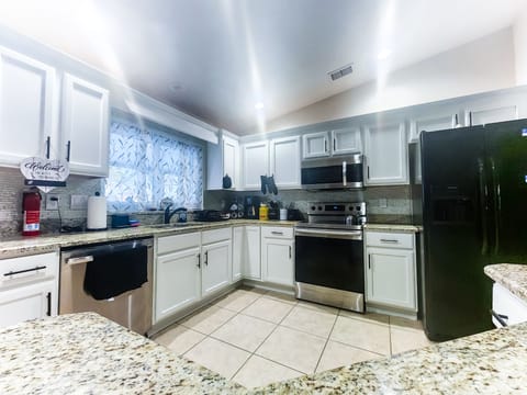 Fully stocked Kitchen with appliances and island with stools