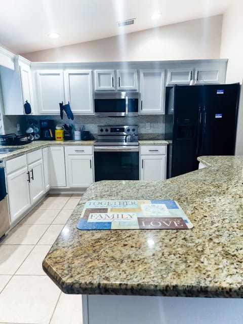 Fully stocked Kitchen with appliances and island with stools