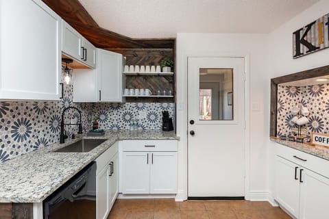 Fully stocked kitchen with most everything you could need. Leads to back deck