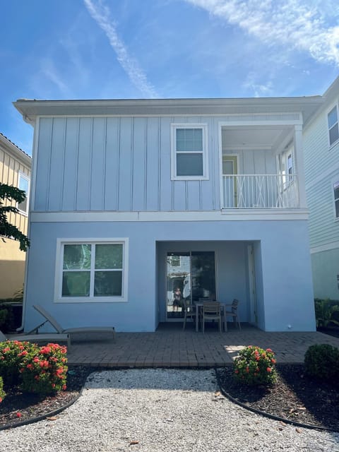 back of house with private balcony off master