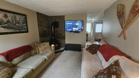 Living Room with 50 inch Roku TV & gas fireplace.