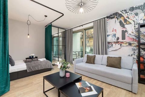 A stylish living room with a large sofa, modern decor, and floor-to-ceiling windows for plenty of natural light.
