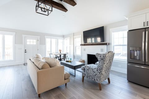 Comfortable seating with smart TV and gas fireplace open to the kitchen.