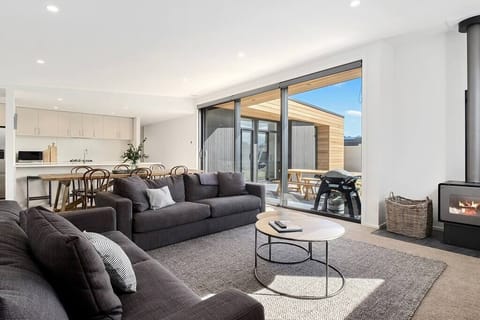 Living room with plenty of firewood for chilly nights. BBQ with outdoor seating. 