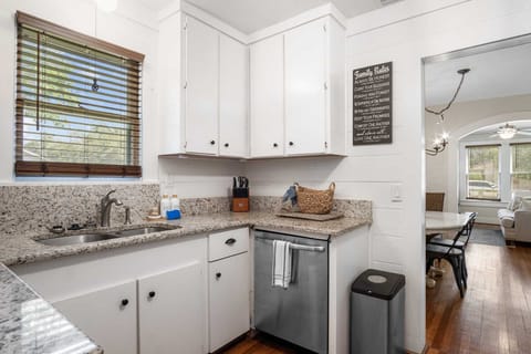 Discover the heart of our home in this fully equipped kitchen, perfect for preparing delicious meals during your stay. Enjoy modern amenities and a seamless flow into the dining area.