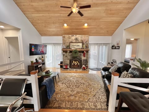 Living room with smart tv and decorative fireplace.