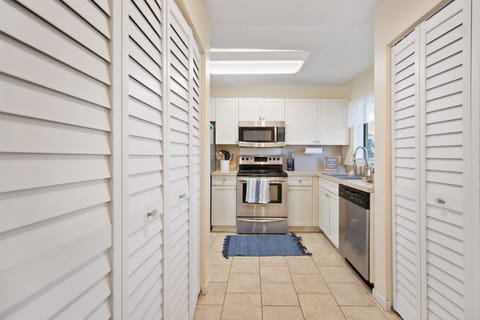 Laundry closet to your left equipped with washer, dryer, iron, iron and more