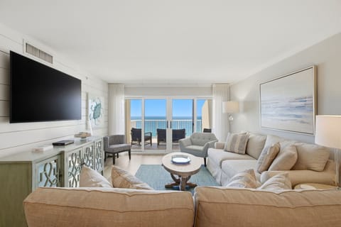Sandy Key 827- Sink into plush coastal comfort while ocean views fill your panoramic windows. Your living room blends serene, beach-inspired decor with spacious seating—perfect for unwinding after sun-soaked days.