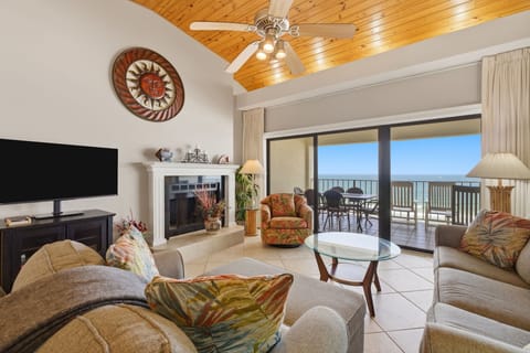 Shipwatch D803- Unwind in this cozy living room with a fireplace and stunning ocean views from your private balcony. Comfortable seating and warm wood ceilings create the perfect retreat.