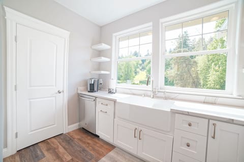Kitchen sink, looking out into beautiful forested hillside. Large pantry.