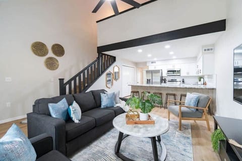 Open-concept living area with modern kitchen and vaulted ceilings
