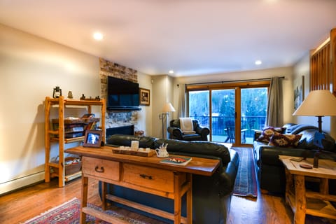Living Room Area - Living room with a flat screen TV, fireplace, and access to a large balcony.