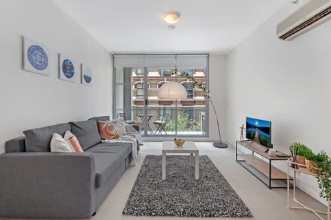 A living area with a 3-seater sofa bed that folds out to a queen.
