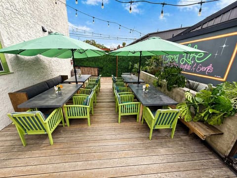 Long Outdoor Dining Setup with String Lights, Elegant Seating, and Evening Ambiance — Stylish, Inviting, and Perfect for Outdoor Meals