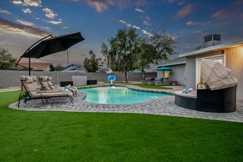 Pool view of furniture and basketball hoop.