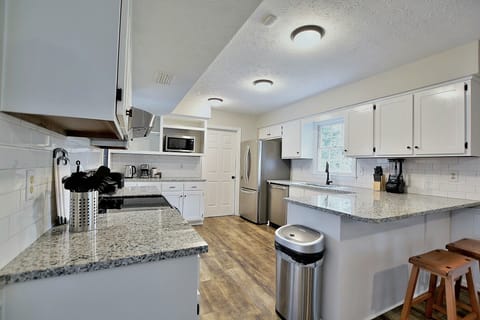 Have few drinks at the kitchen bar while watching the designated chef in action