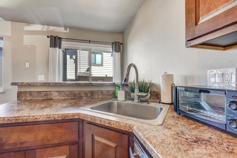 Bright kitchen with a spacious countertop and sink area, perfect for meal prep with a view.