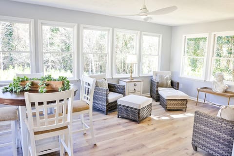 Gorgeous sunroom with a breakfast set and lots of extra seating