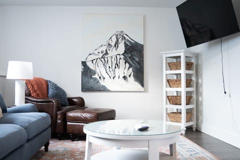 Living room with custom Lone Peak art and 55" smart TV.