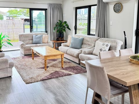 Spacious open plan living area with comfortable seating and indoor–outdoor flow.