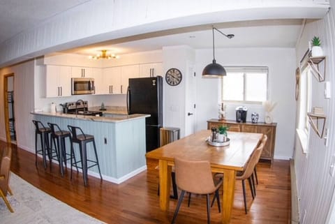 Wood dining table with seating for six (four chairs and bench with room for two).  Fully equipped coffee bar complete with Keurig, coffee pot, and French press. The sideboard is stocked with a dozen classic board/card games.